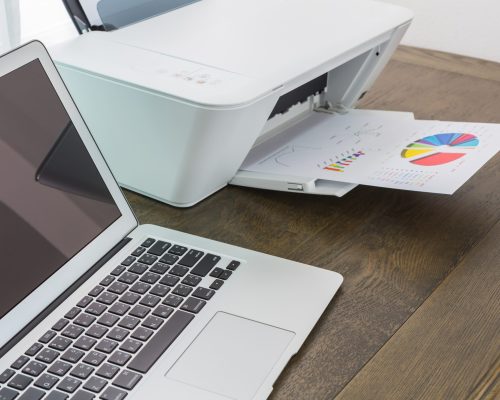 printer and Laptop on wood table
